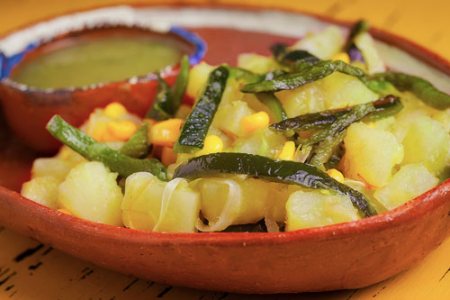 Potatoes with Peppers in a clay dish 